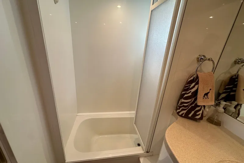 Slide: The Image of Bathroom interior of 2005 Jefferson Pilothouse 63 yacht with shower and decorative towels. - 38
