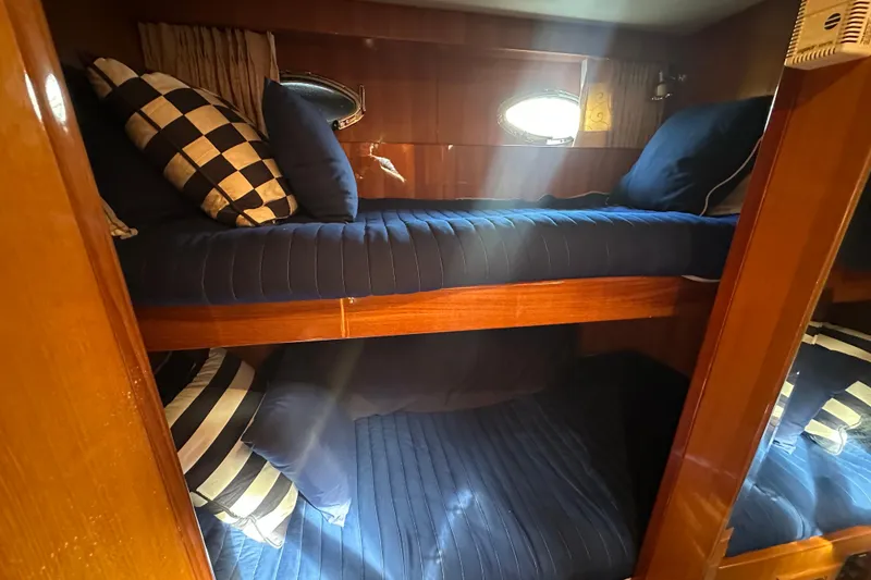 Slide: The Image of Bunk beds with blue bedding in 2005 Jefferson Pilothouse 63 yacht cabin. - 39