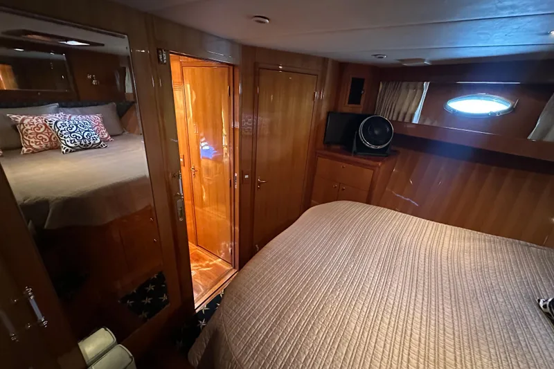 Slide: The Image of Luxurious cabin interior of 2005 Jefferson Pilothouse 63 yacht with wood paneling and cozy bedding. - 41