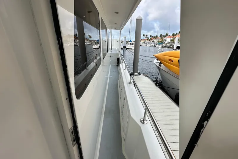 Slide: The Image of Side deck view of 2005 Jefferson Pilothouse 63 yacht docked at marina. - 43