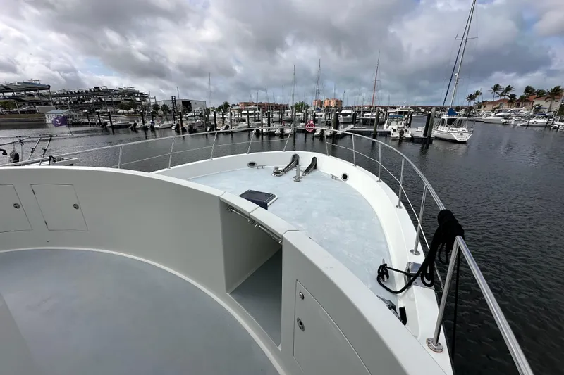 Slide: The Image of 2005 Jefferson Pilothouse 63 yacht docked in a marina under cloudy skies. - 45