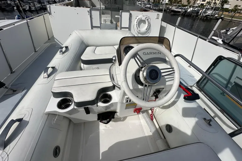 Slide: The Image of 2005 Jefferson Pilothouse 63 boat helm with Garmin navigation system, docked at marina. - 49