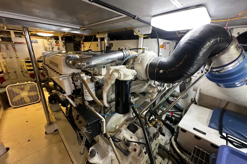Slide: The Image of Engine room of a 2005 Jefferson Pilothouse 63 yacht, showcasing mechanical components. - 55