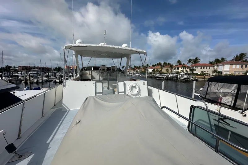 Slide: The Image of 2005 Jefferson Pilothouse 63 yacht docked at marina under blue sky. - 7