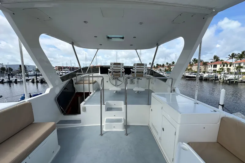 Slide: The Image of Spacious deck of 2005 Jefferson Pilothouse 63 yacht, docked at marina. - 8