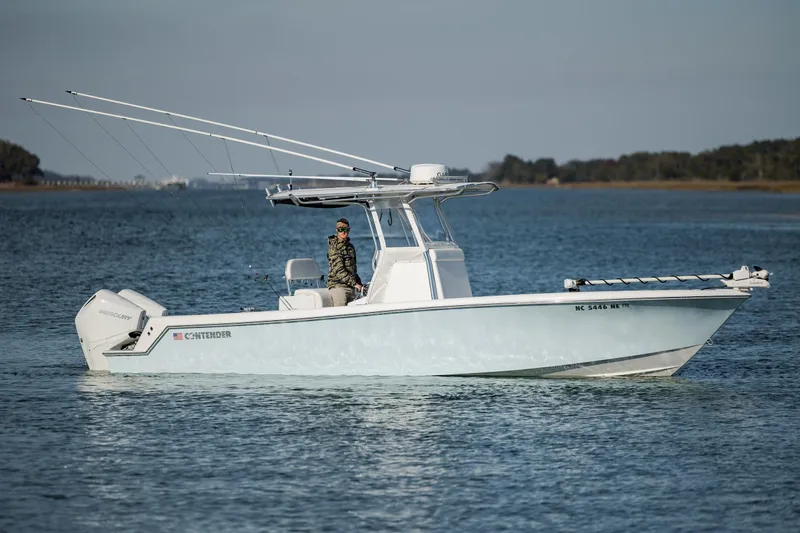 The Image of 2024 Contender 28 Tournament boat on calm water, featuring dual Mercury engines. - 0