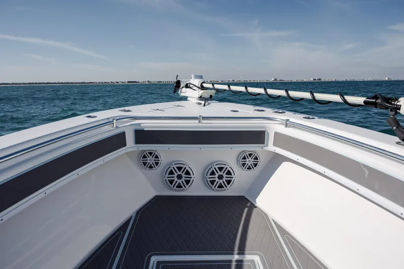 Slide: The Image of 2024 Contender 28 Tournament boat bow with speakers, ocean view, and clear sky. - 10