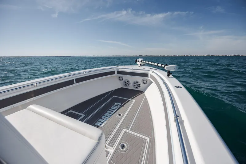 Slide: The Image of 2024 Contender 28 Tournament boat on open water, showcasing sleek deck design and ocean view. - 11