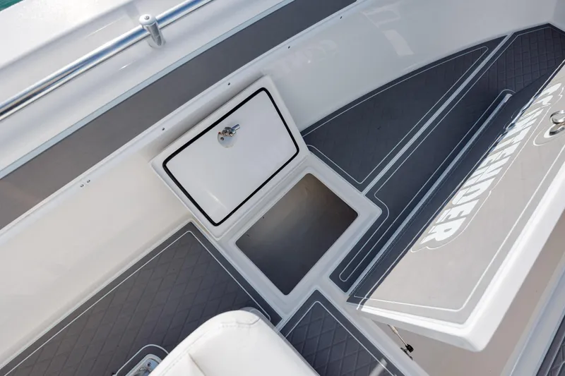 Slide: The Image of 2024 Contender 28 Tournament boat interior with storage compartment and cushioned seating. - 17