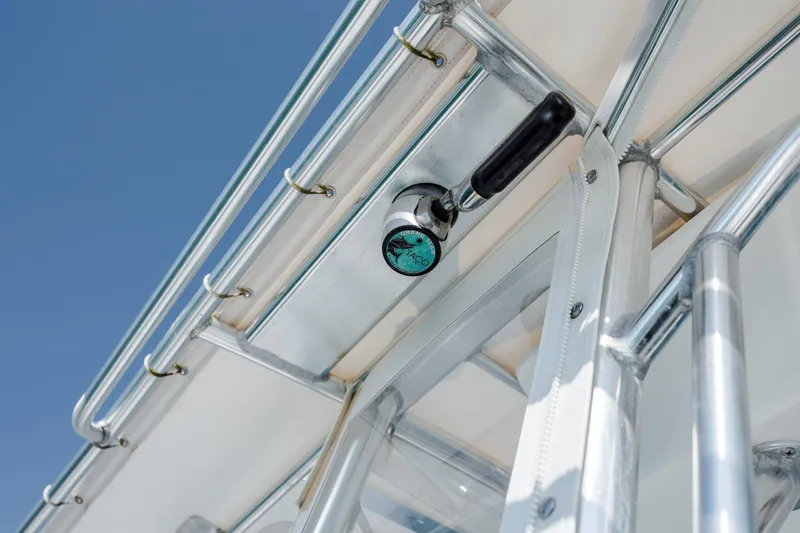 Slide: The Image of Close-up of 2024 Contender 28 Tournament boat's metal framework and handle against blue sky. - 25