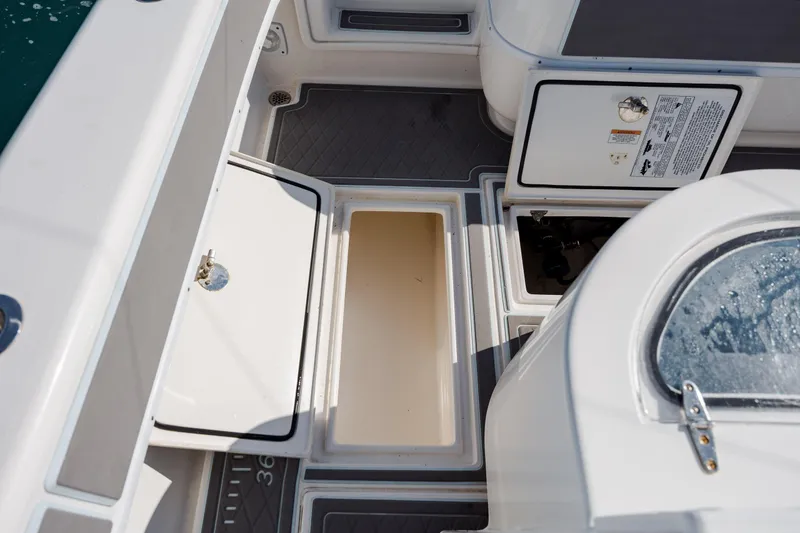 Slide: The Image of 2024 Contender 28 Tournament boat interior with open storage compartments and non-slip flooring. - 30