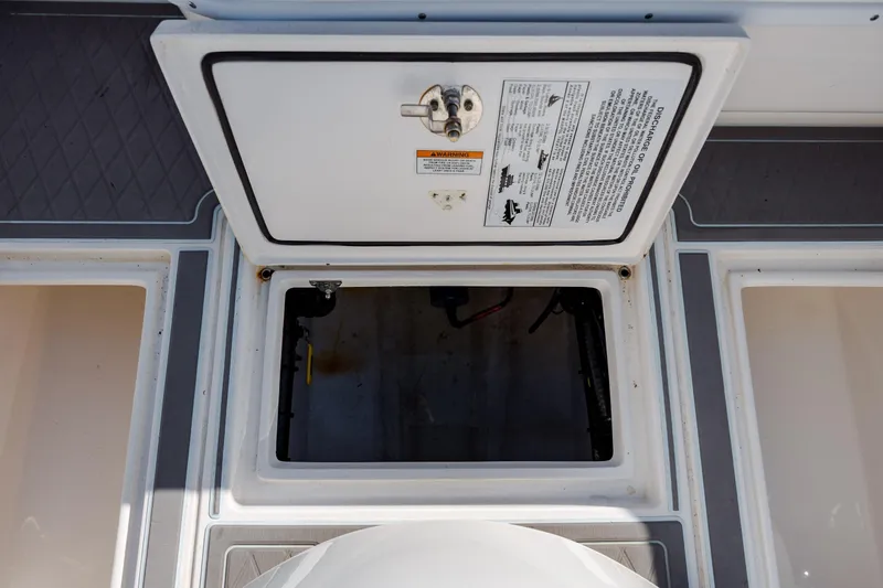 Slide: The Image of Open hatch on 2024 Contender 28 Tournament boat deck, showing storage compartment. - 31