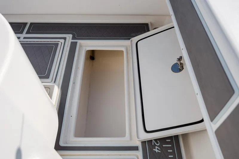 Slide: The Image of 2024 Contender 28 Tournament boat storage compartment with open hatch and non-slip flooring. - 32