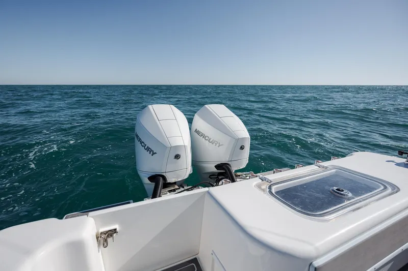 Slide: The Image of 2024 Contender 28 Tournament boat with dual Mercury outboard engines on open sea. - 33