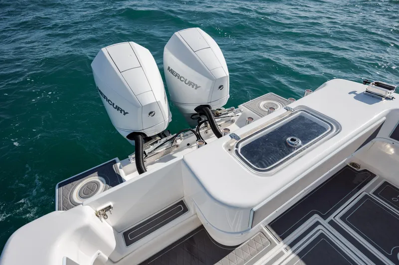 Slide: The Image of 2024 Contender 28 Tournament boat with dual Mercury engines on open water. - 34