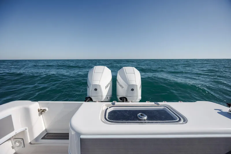 Slide: The Image of 2024 Contender 28 Tournament boat with dual outboard motors on open sea. - 35