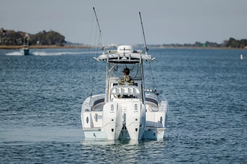 Slide: The Image of 2024 Contender 28 Tournament boat cruising on a calm waterway. - 4