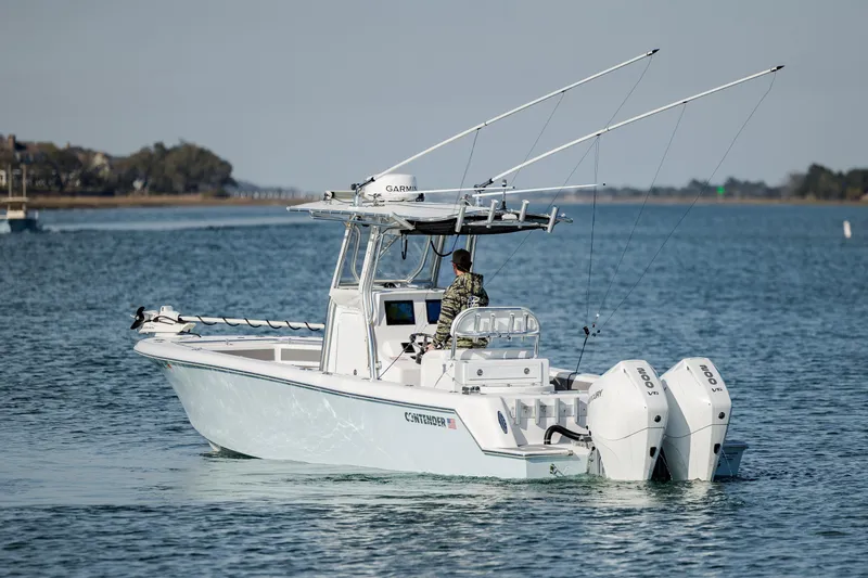 Slide: The Image of 2024 Contender 28 Tournament boat with dual engines on a calm sea. - 5