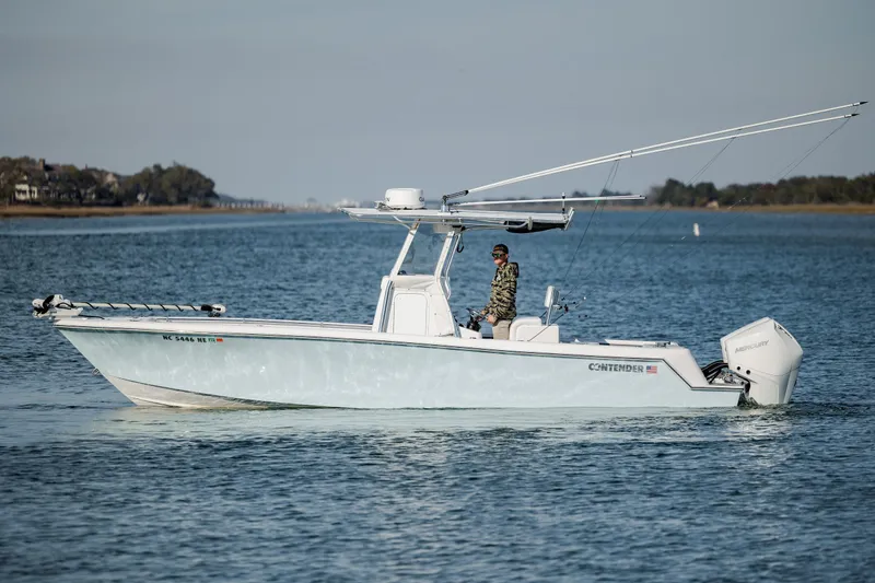 Slide: The Image of 2024 Contender 28 Tournament boat cruising on calm waters with a person onboard. - 6