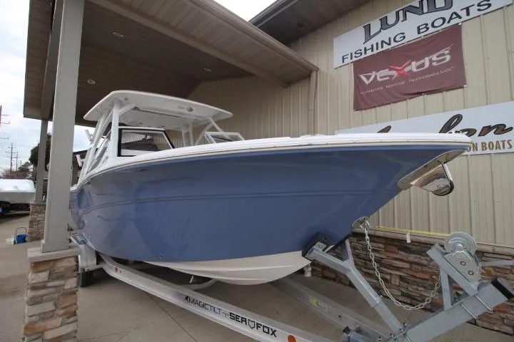Slide: The Image of 2026 Sea Fox 268 Traveler boat on trailer outside a fishing boat dealership. - 1