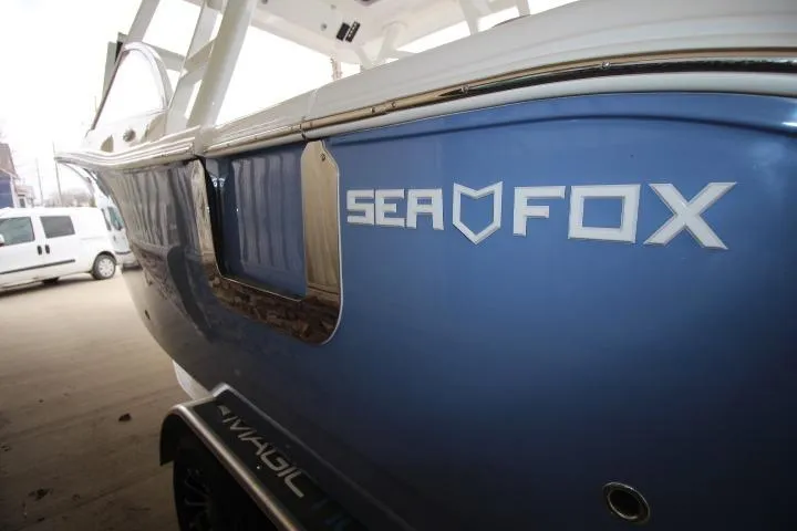 Slide: The Image of 2026 Sea Fox 268 Traveler boat, blue hull, close-up view. - 2