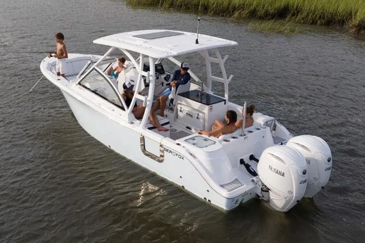 Slide: The Image of Manufacturer Provided Image: 2025 Sea Fox 268 Traveler boat with passengers on a calm waterway. - 26