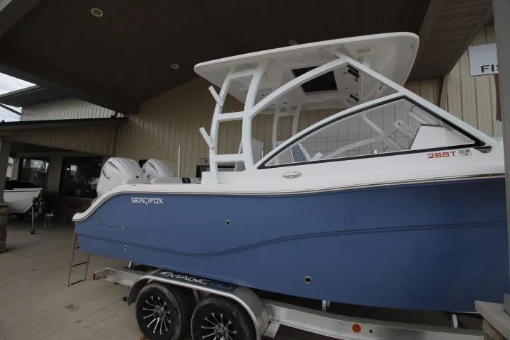 Slide: The Image of 2026 Sea Fox 268 Traveler boat on trailer, blue hull, dual engines, outdoor display. - 3