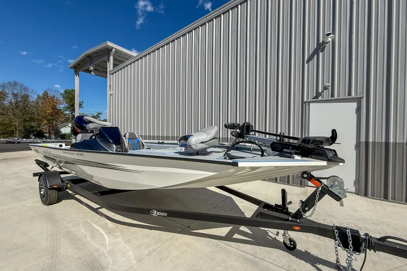 Slide: The Image of 2026 G3 Sportsman 1810 SE boat on trailer, parked outside a metal building. - 2