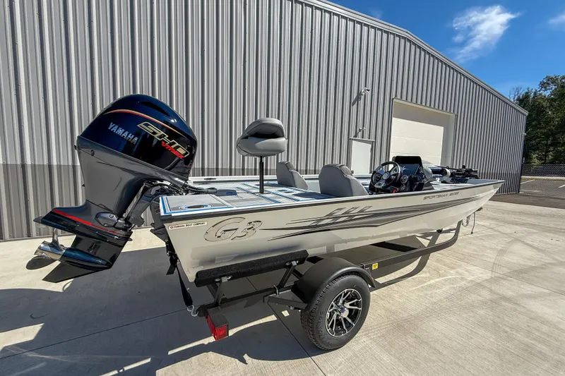 Slide: The Image of 2026 G3 Sportsman 1810 SE boat with Yamaha engine, parked outside a metal building. - 3