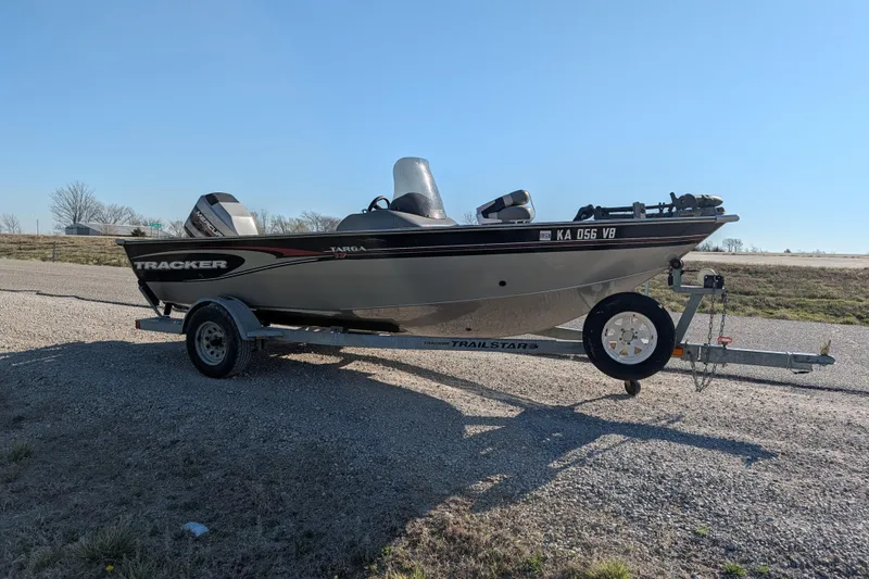 Slide: The Image of 2003 Tracker Targa 17 SC boat on a trailer, parked on a gravel road. - 11