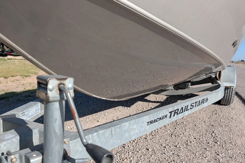 Slide: The Image of 2003 Tracker Targa 17 SC boat on a Trailstar trailer, parked on gravel. - 13