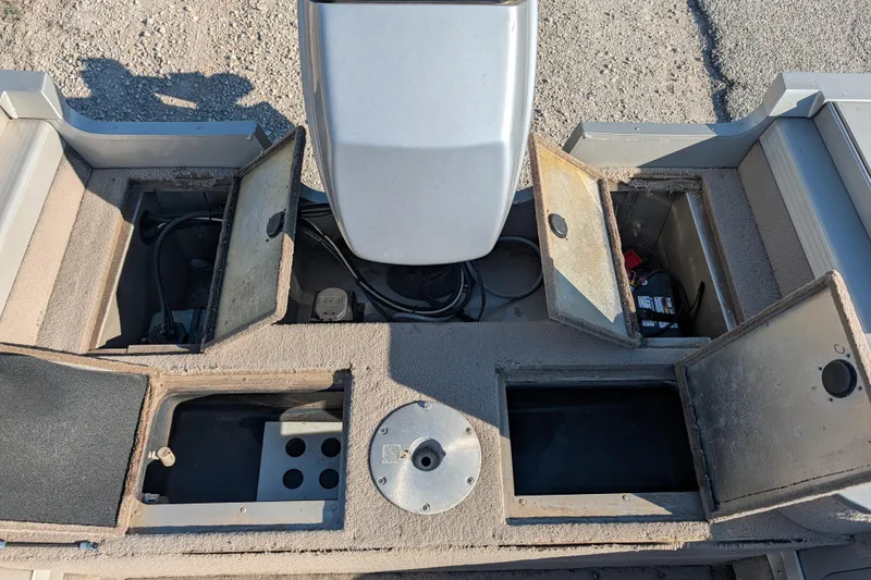 Slide: The Image of 2003 Tracker Targa 17 SC boat interior with open storage compartments and visible wiring. - 19