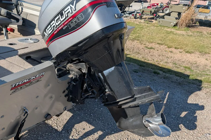 Slide: The Image of 2003 Tracker Targa 17 SC boat with Mercury Nitro 150 engine, parked on gravel. - 24