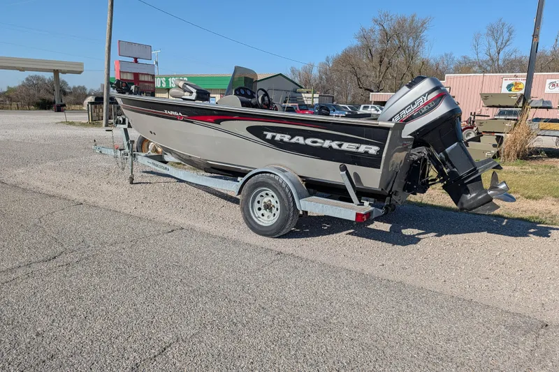 Slide: The Image of 2003 Tracker Targa 17 SC boat on trailer, parked outdoors on a sunny day. - 5