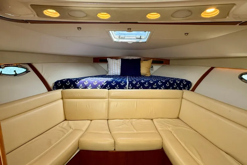 Slide: The Image of Luxurious interior of 2007 Tiara Yachts 3000 Open with cozy seating and nautical bedding. - 10