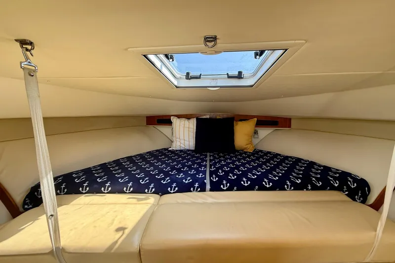 Slide: The Image of Cozy cabin interior of 2007 Tiara Yachts 3000 Open with nautical-themed bedding. - 13
