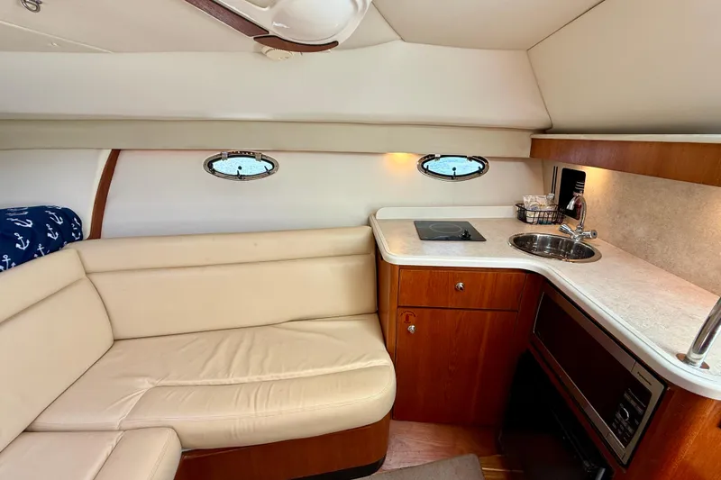 Slide: The Image of 2007 Tiara Yachts 3000 Open interior with kitchenette and seating area. - 15