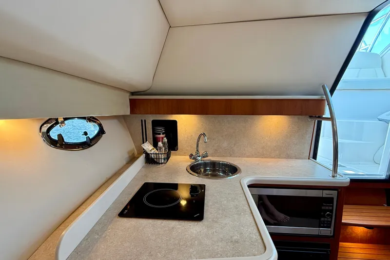 Slide: The Image of 2007 Tiara Yachts 3000 Open galley with sink, stove, and microwave. - 16