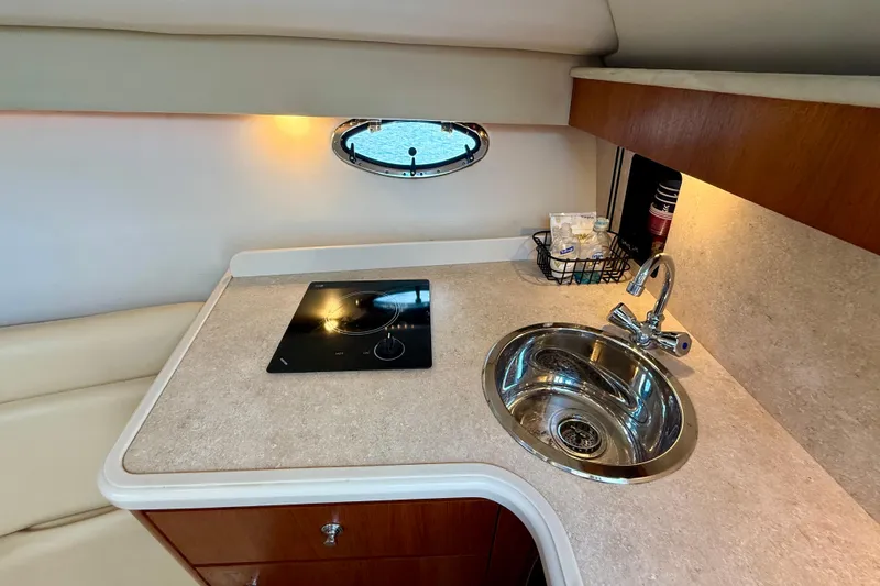 Slide: The Image of Compact galley in 2007 Tiara Yachts 3000 Open, featuring sink and stovetop. - 17