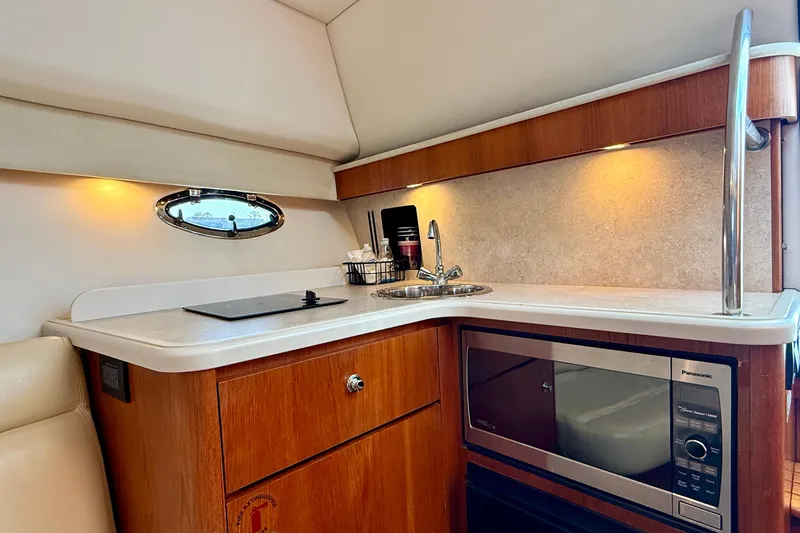 Slide: The Image of 2007 Tiara Yachts 3000 Open galley with sink, stove, and microwave. - 18