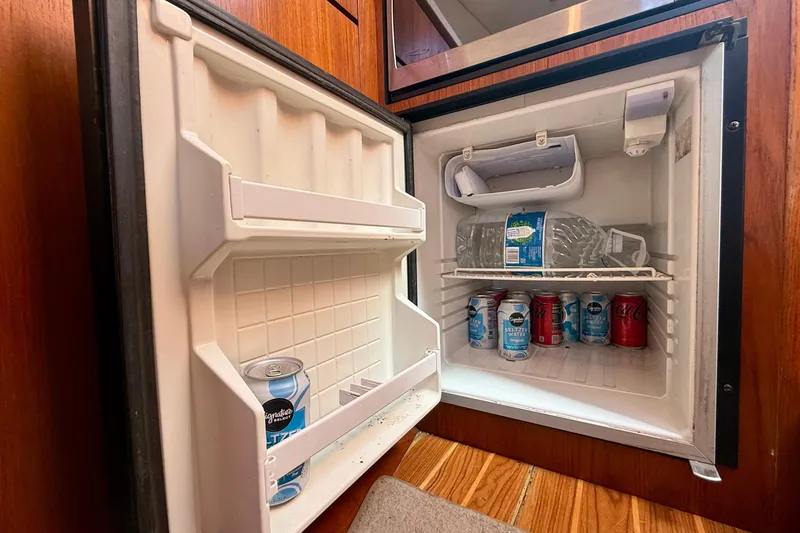 Slide: The Image of Mini fridge stocked with beverages inside a 2007 Tiara Yachts 3000 Open. - 19