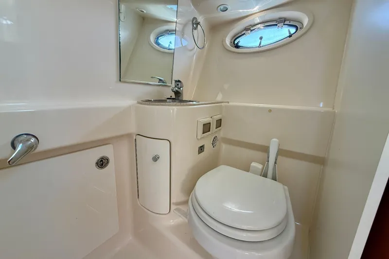 Slide: The Image of 2007 Tiara Yachts 3000 Open bathroom with sink, toilet, and porthole window. - 21