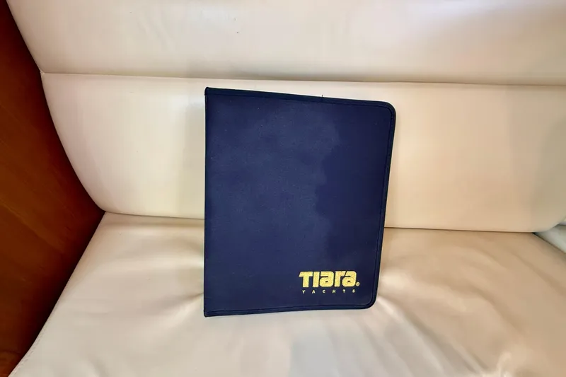 Slide: The Image of Blue Tiara Yachts folder on white seat, 2007 Tiara 3000 Open model. - 25