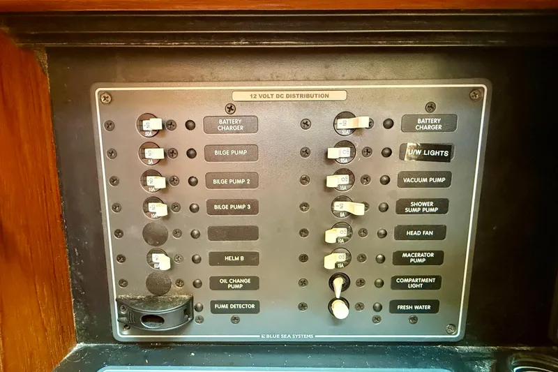 Slide: The Image of Control panel of a 2007 Tiara Yachts 3000 Open, featuring various switches and circuit breakers. - 27