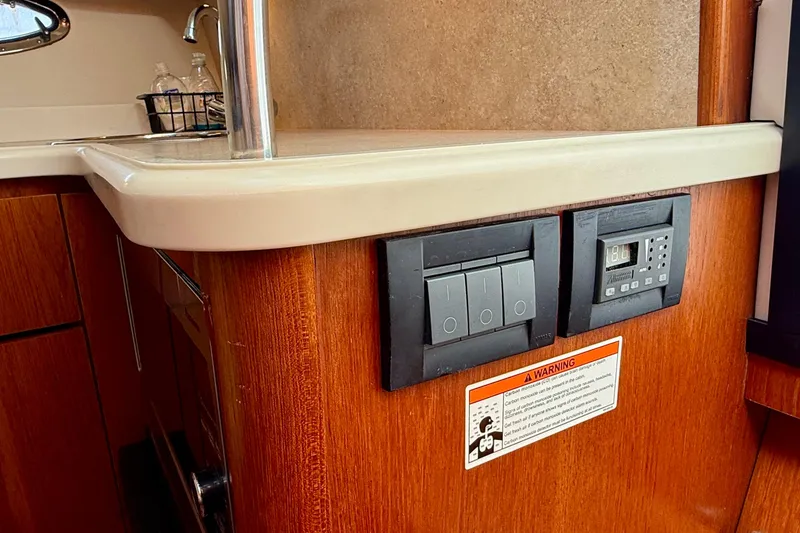 Slide: The Image of 2007 Tiara Yachts 3000 Open interior with control panel and wooden cabinetry. - 29