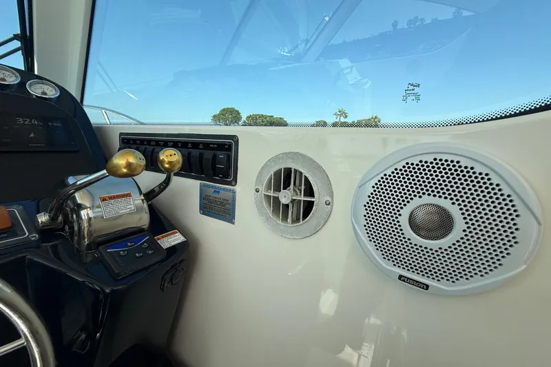 Slide: The Image of 2007 Tiara Yachts 3000 Open helm with controls, speaker, and dashboard instruments. - 36