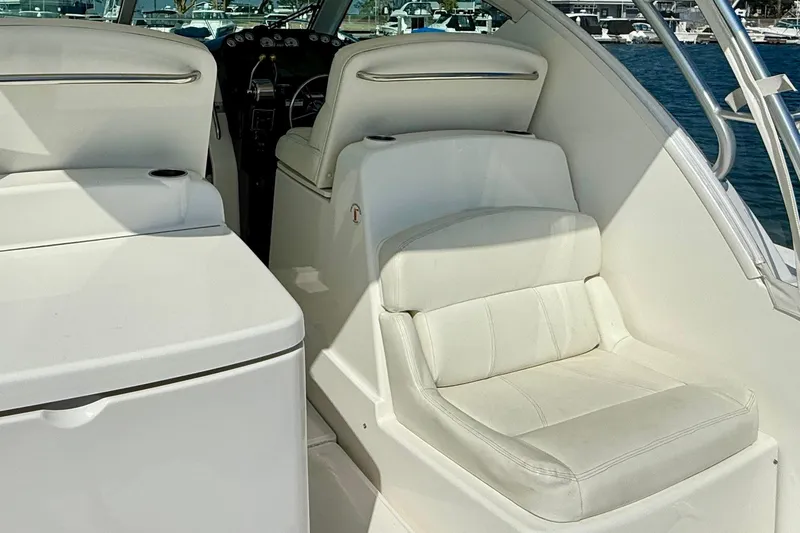 Slide: The Image of Interior view of 2007 Tiara Yachts 3000 Open, featuring white seating and helm area. - 41
