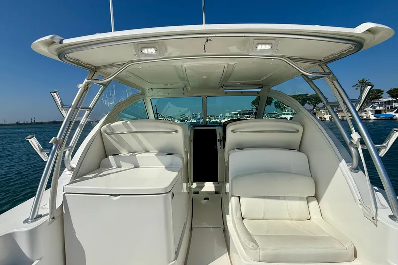 Slide: The Image of 2007 Tiara Yachts 3000 Open interior with seating, docked in a marina. - 42