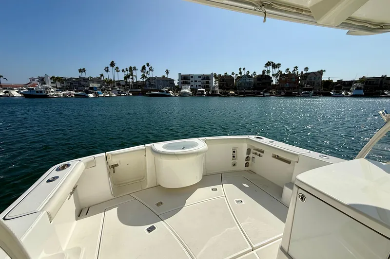 Slide: The Image of 2007 Tiara Yachts 3000 Open boat deck with marina view and clear blue water. - 45