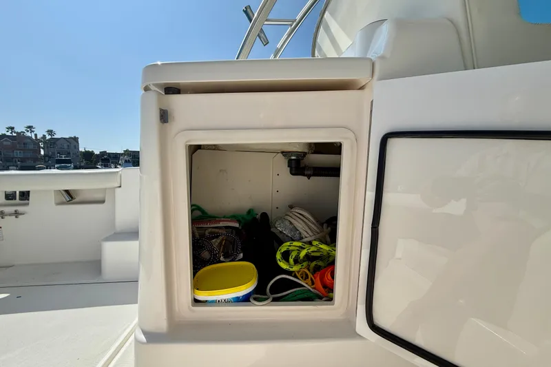 Slide: The Image of Storage compartment on a 2007 Tiara Yachts 3000 Open, containing ropes and supplies. - 46
